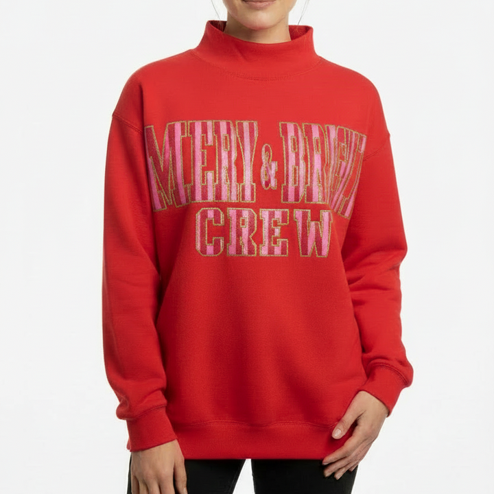 Merry And Bright Mock Neck Sweatshirt featuring “MERRY &amp; BRIGHT CREW” in large festive letters on the front; available in sizes S-XXL.
