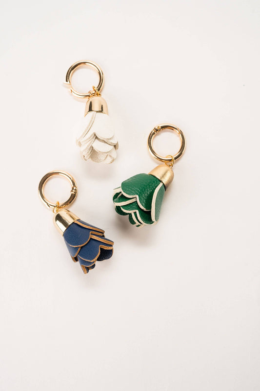 Leather Flower Tassel keychains in white, green, and navy blue faux leather. Sizes: Small, Medium, Large.