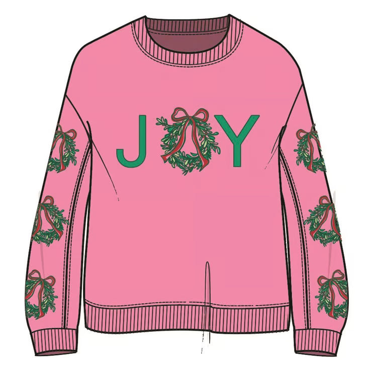 Pink Sarah Joy Wreath sweatshirt with a ribbed crew neck and cuffs, green “JOY” graphic with a wreath “O,” and sleeve wreath motifs. Available in various sizes.