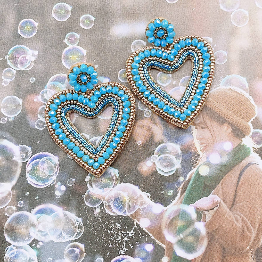 Two blue heart earrings made of seed beads and 24k gold plating. Available in small, medium, and large sizes.