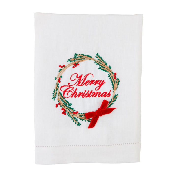 White faux linen Christmas Embroidered Bow Towels featuring a green pine and red berry wreath, a tartan bow, and “Merry Christmas” in red script.