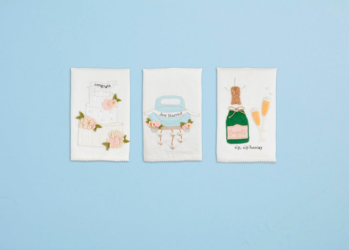 Wedding Beaded Tea Towels in premium cotton featuring: cake with "congrats," car with "just married," and champagne glasses with "sip sip hooray." Available in standard size.