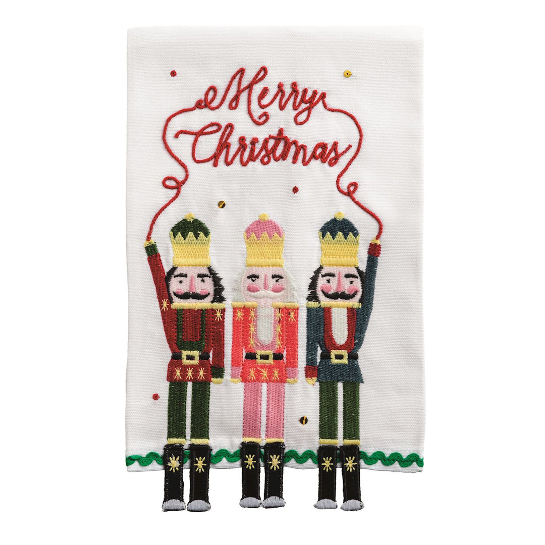Dangle Embroidery Christmas Towels, a white embroidered hand towel featuring three nutcrackers holding a “Merry Christmas” string with dangling legs.