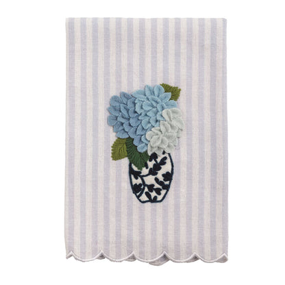 White and lavender striped tea towel with scalloped edge, embroidered vase, blue flowers. Available in standard size.