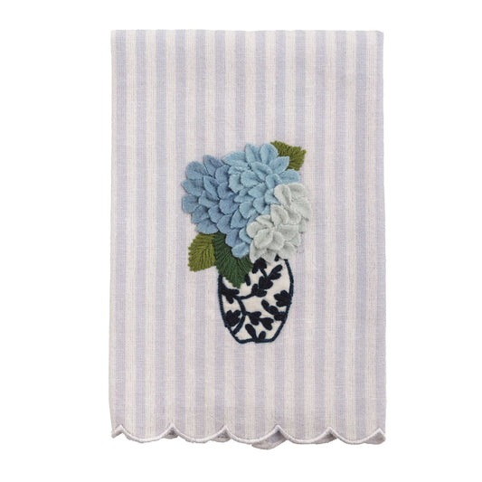 White and lavender striped tea towel with scalloped edge, embroidered vase, blue flowers. Available in standard size.