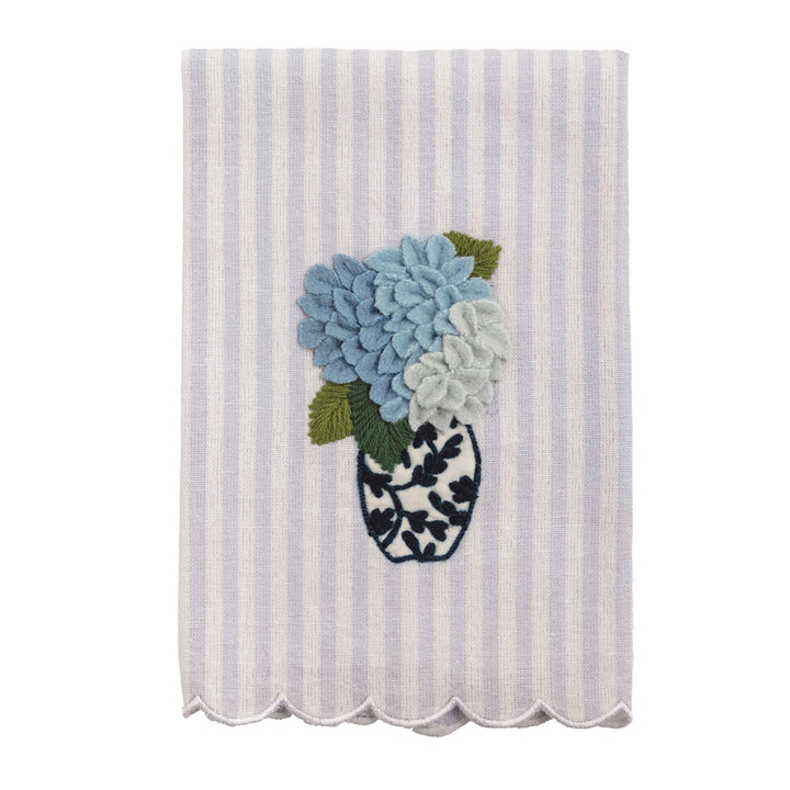 White and lavender striped tea towel with scalloped edge, embroidered vase, blue flowers. Available in standard size.