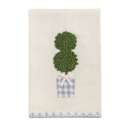 White cotton tea towel with embroidered topiary, blue-checkered pot, white bow, blue zigzag border. Size: 20" x 28".