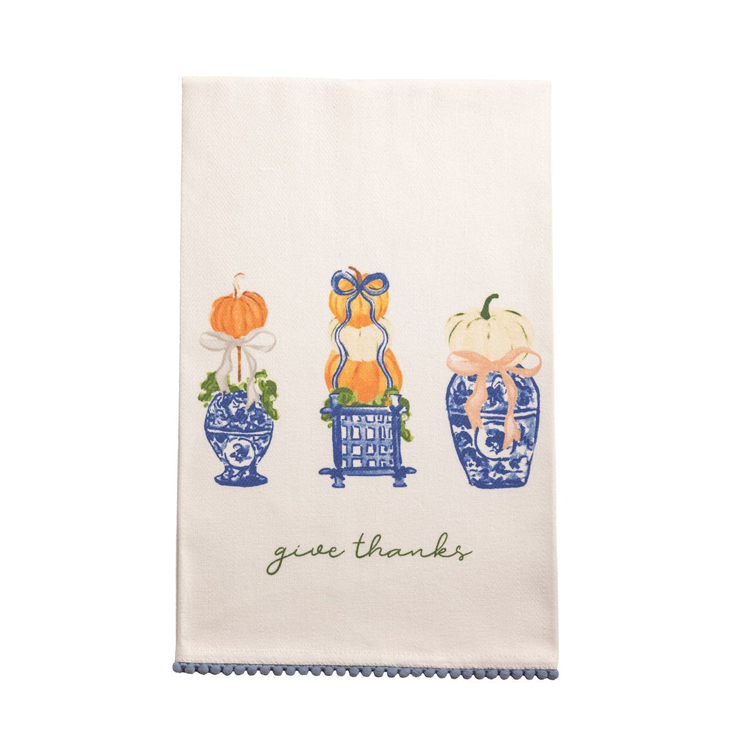 White cotton hand towel with blue trim, three blue vases holding pumpkins and greenery, and “give thanks” embroidered in green. Available sizes: standard hand towel.
