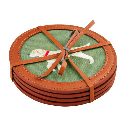 Embroidered Icon Coaster Set: Four round needlepoint coasters with green fabric centers, embroidered white dog with red collar, faux leather trim, brown leather strap. Size: Standard coaster dimensions.