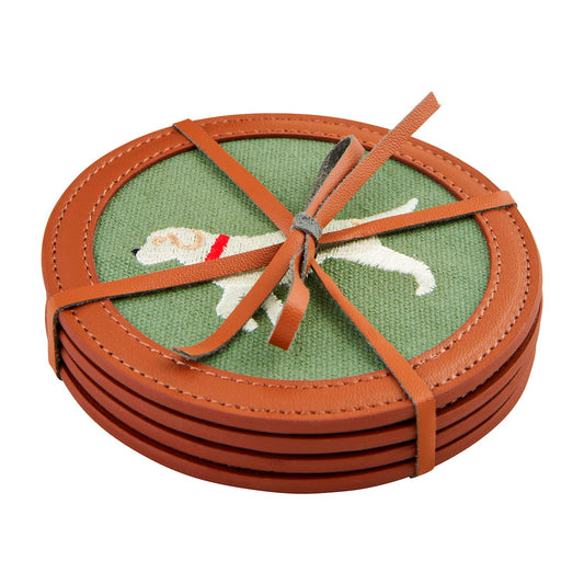 Embroidered Icon Coaster Set: Four round needlepoint coasters with green fabric centers, embroidered white dog with red collar, faux leather trim, brown leather strap. Size: Standard coaster dimensions.