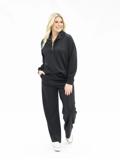 Black Butter Soft Pants with a relaxed fit. Available in sizes XS–XL.