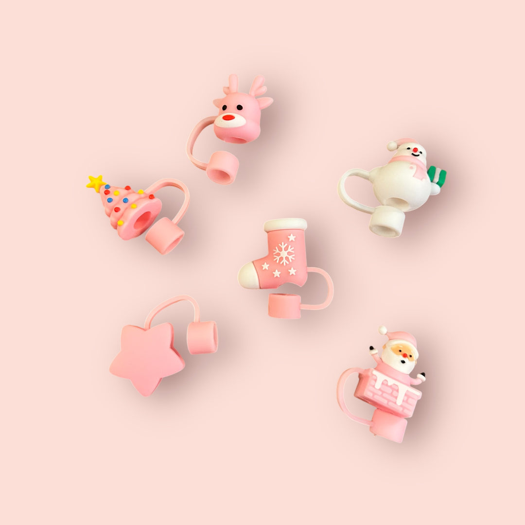 Set of five pink Christmas straw covers: tree, reindeer, stocking, star, and Santa in a chimney.