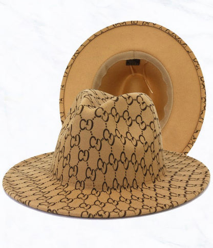 Tan Wide Brim Hat with bold brown interlocking "GG" pattern; pattern visible inside and outside. Sizes: S, M, L, XL.