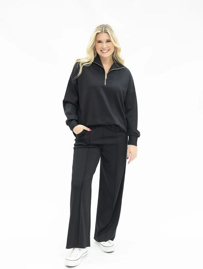 Black Butter Soft Pants in a wide-leg silhouette, available in sizes XS–XL.