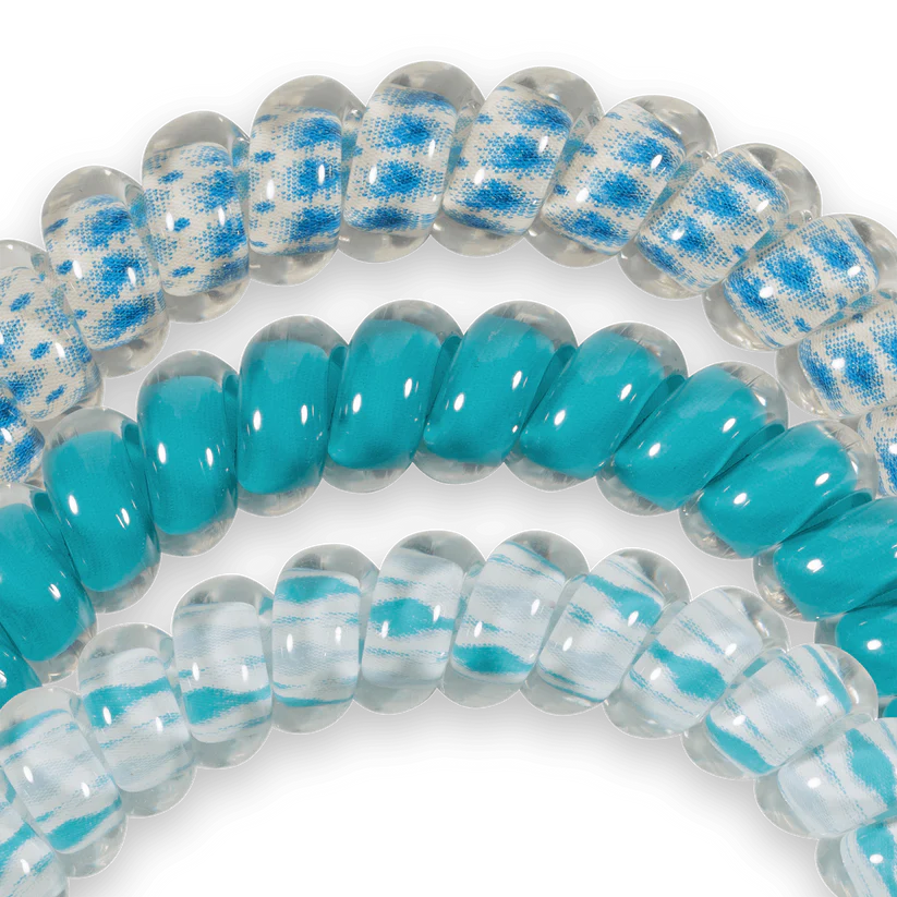 Three TELETIES Hair Ties: two blue/white patterned, one solid turquoise. Available in small and large sizes.