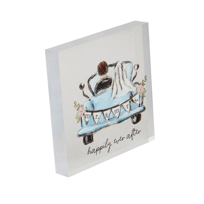 The Acrylic Wedding Plaque is a square acrylic block with a cartoon of a couple in a blue car, featuring "mr. & mrs." and pink flowers. It includes the text "happily ever after" with the veil draping over the car. Available sizes: 6x6 inches, 8x8 inches.