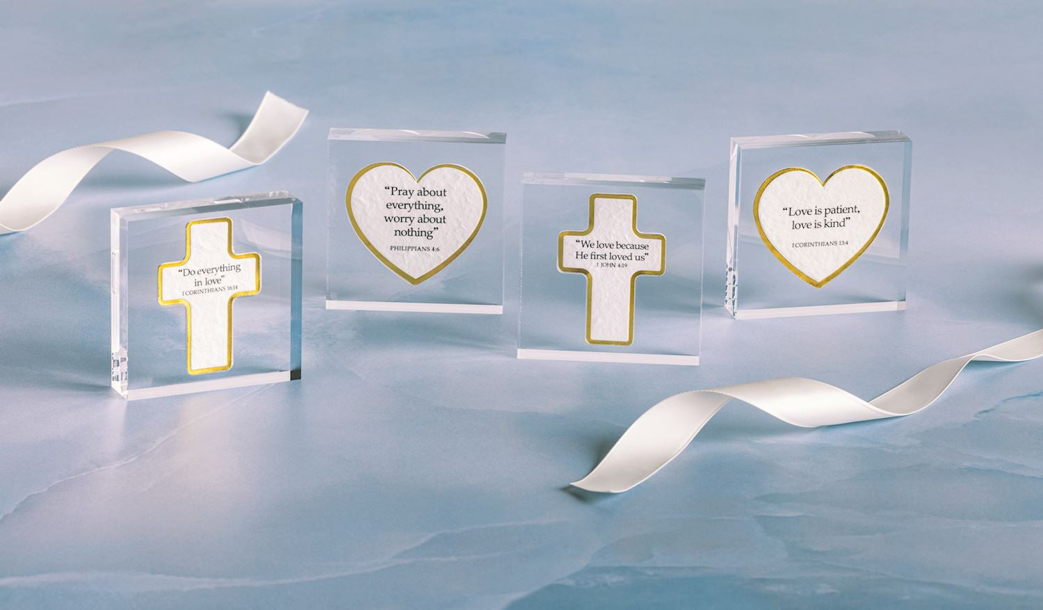 Set of four clear acrylic plaques with gold-edged crosses and hearts, each with Bible verses; available in small and large sizes.