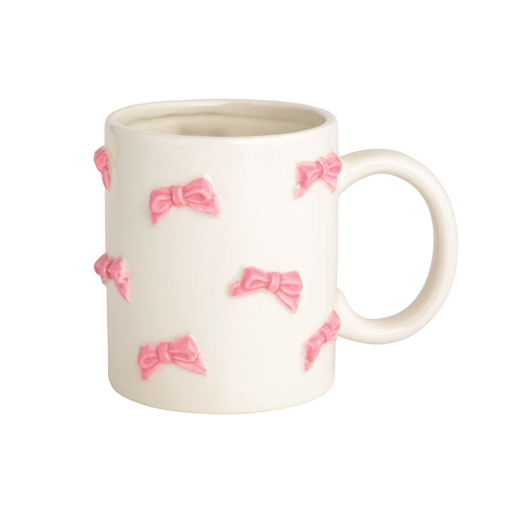 White ceramic mugs with raised pink bows, smooth handle, glossy finish. Available in 11oz and 15oz sizes.