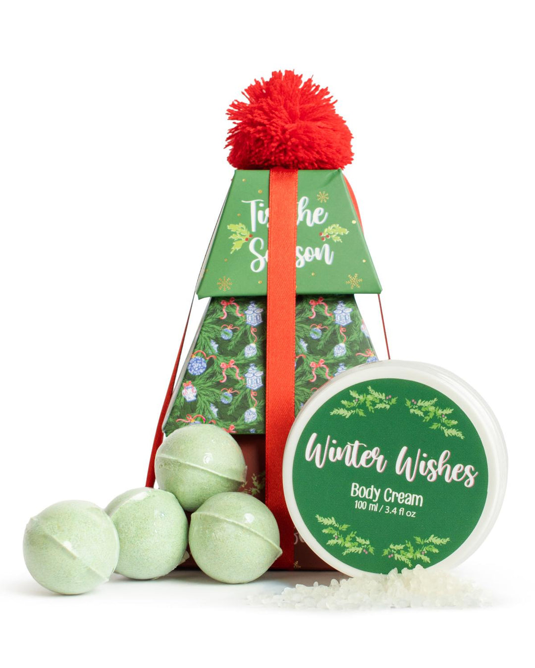 ‘Tis The Season Bath Gift Set | Winter Wishes, includes four light green bath soak bombs, one jar of body cream, and a pyramid-shaped gift box with a red pom-pom.