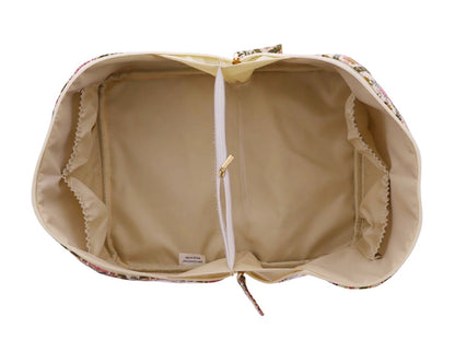 The Travel Organizer | Large has an open floral pattern, beige interior, central zippered pocket, and elastic side pockets. Available in large size.