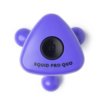 Purple triangular body massager with three rounded legs, black button, and "SQUID PRO QUO" printed. Sizes: multiple options.