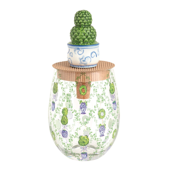 Clear stemless wine glass with green and purple topiary designs, cardboard lid, and ceramic topiary topper. Sizes available.