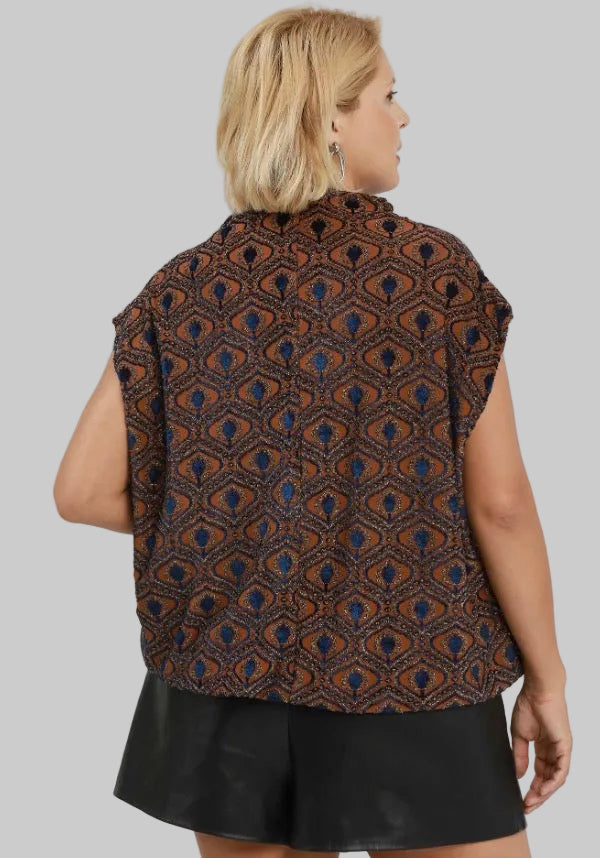Sleeveless rust velvet mock neck top with a rust and dark blue geometric pattern and bubble silhouette.