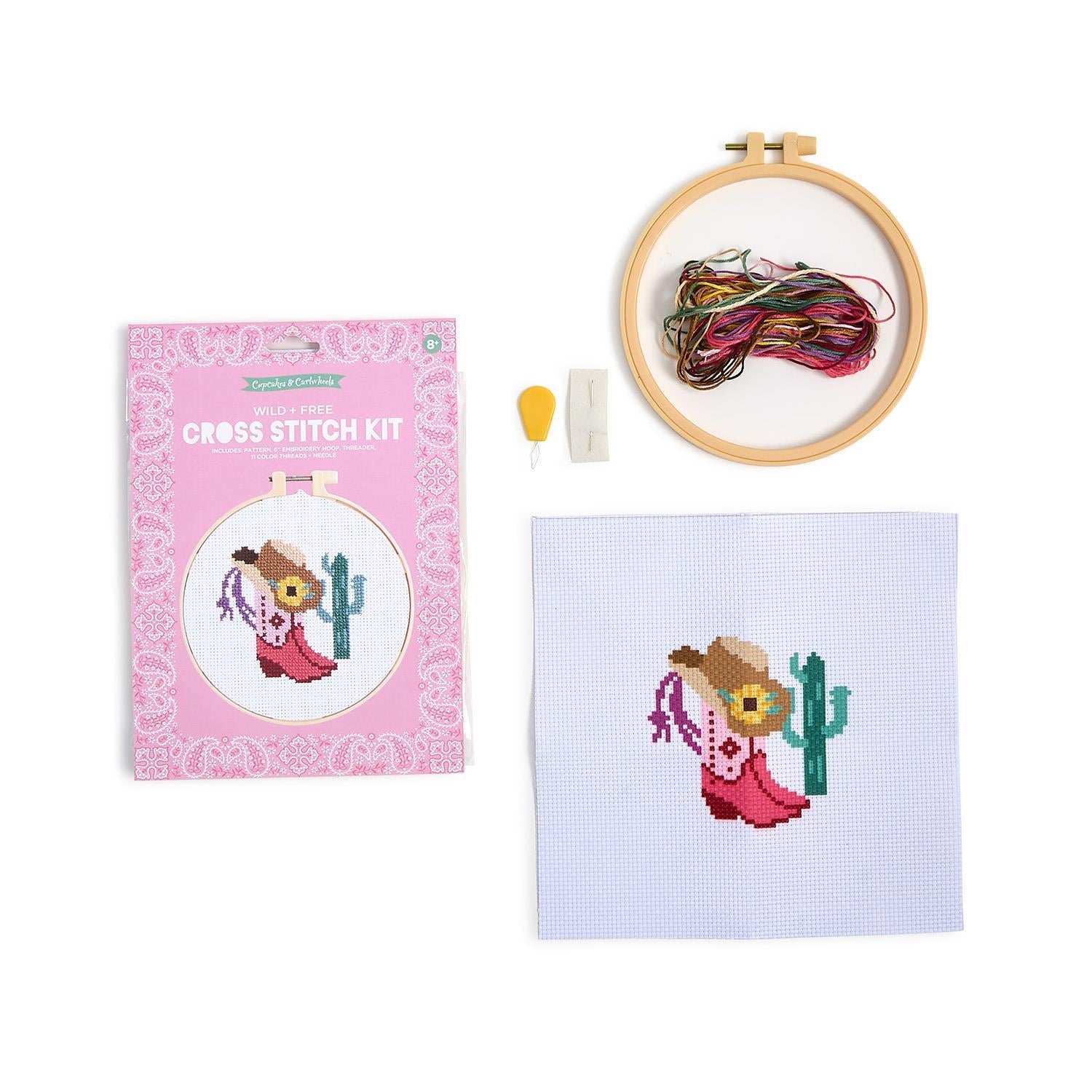 The Wild & Free Cross Stitch Kit in a pink box includes hoop, threads, needle, and aida cloth. Available in multiple sizes.