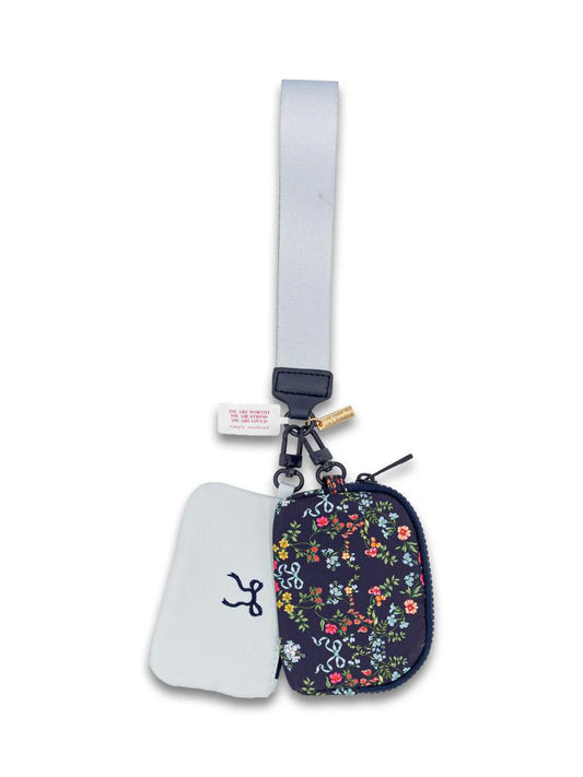 Ribbon and Flowers ID Coin Wristlet with small floral print, light gray strap, white tag, partially open to reveal white interior with blue pattern. Available in one size.