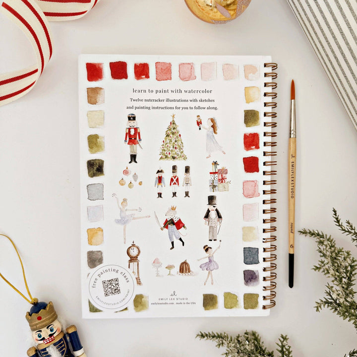 Spiral-bound Nutcracker watercolor workbook with illustrations, painting instructions, and color swatches.