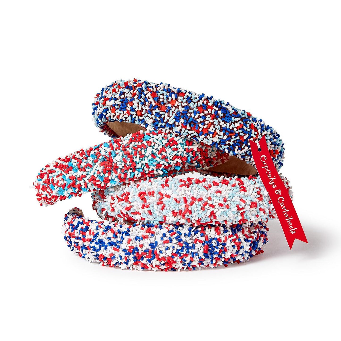 Three headbands with red, white, and blue sprinkles. Available in child and adult sizes. Festive for holidays or events.