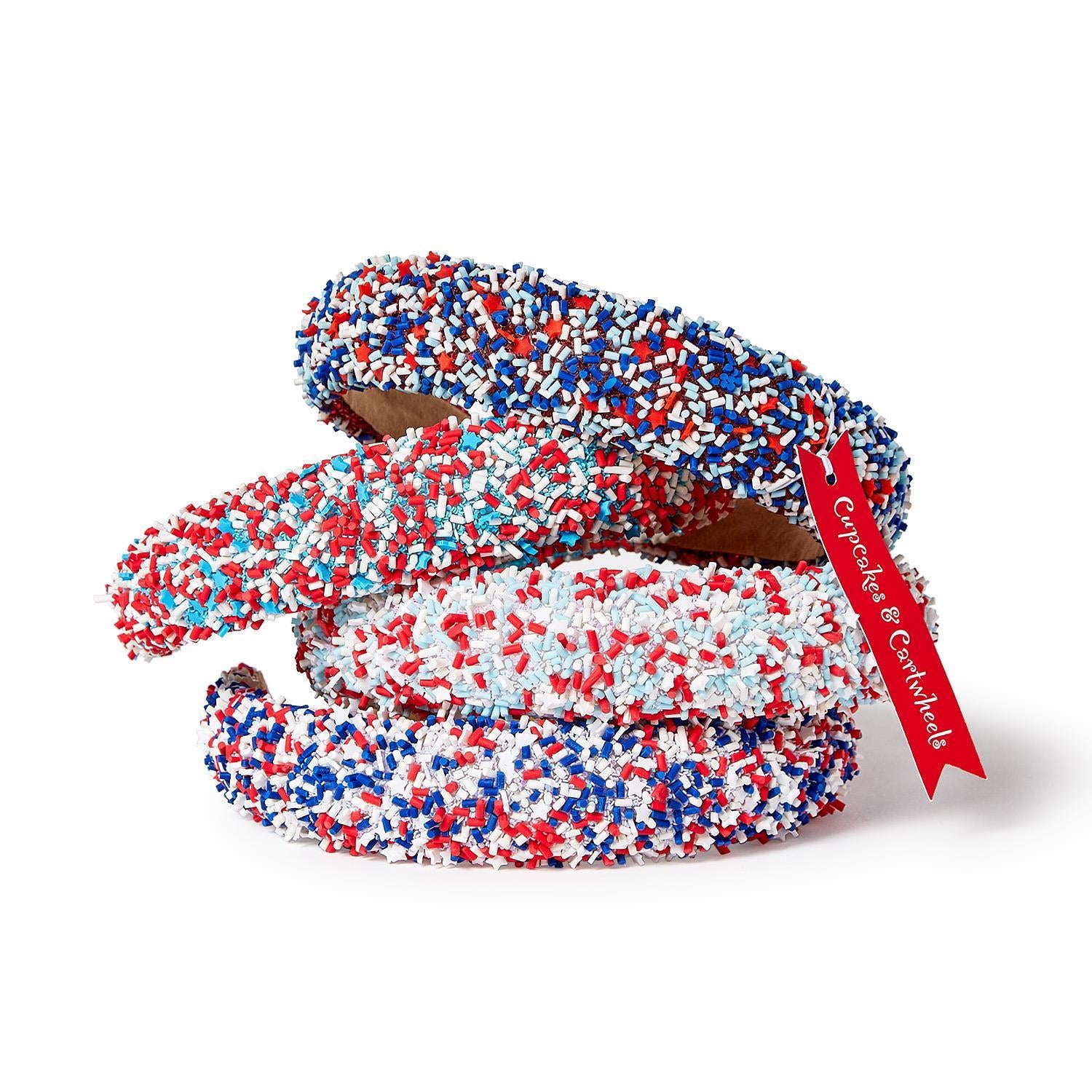 Three headbands with red, white, and blue sprinkles. Available in child and adult sizes. Festive for holidays or events.