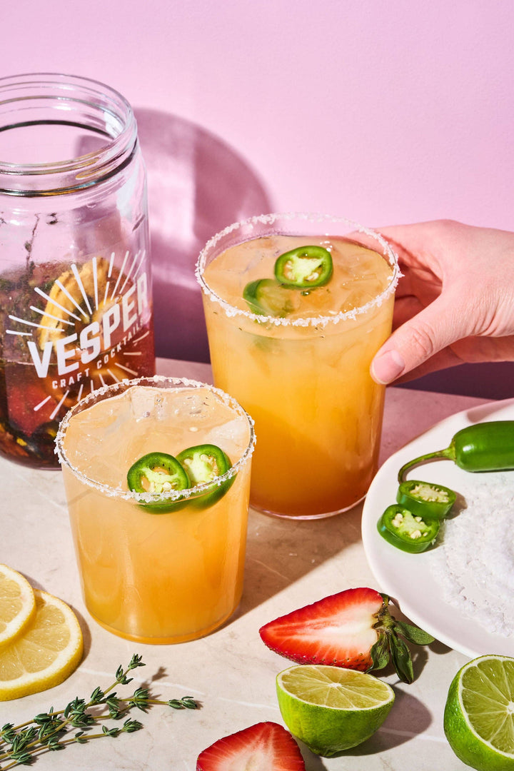 32 oz Craft Cocktail Kit - Jalapeño Margarita shown with two salt-rimmed, jalapeño-garnished glasses.