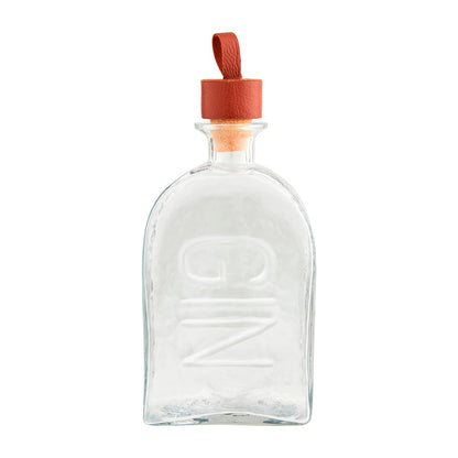 The Embossed Glass Decanters are clear glass bottles with "GIN" embossed on the front. They feature a wooden stopper and a brown leather loop. Available in 750ml size.