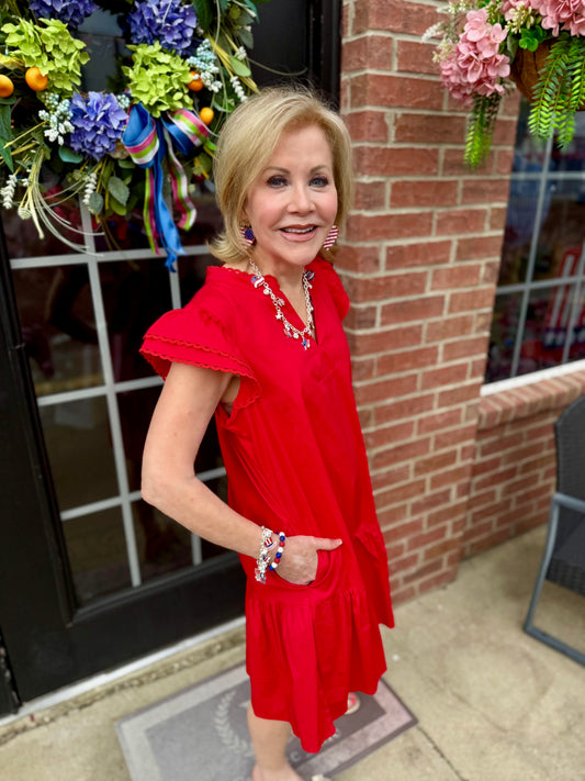 Sierra Red Dress with flutter sleeves and pockets. Available in sizes XS–XXL.