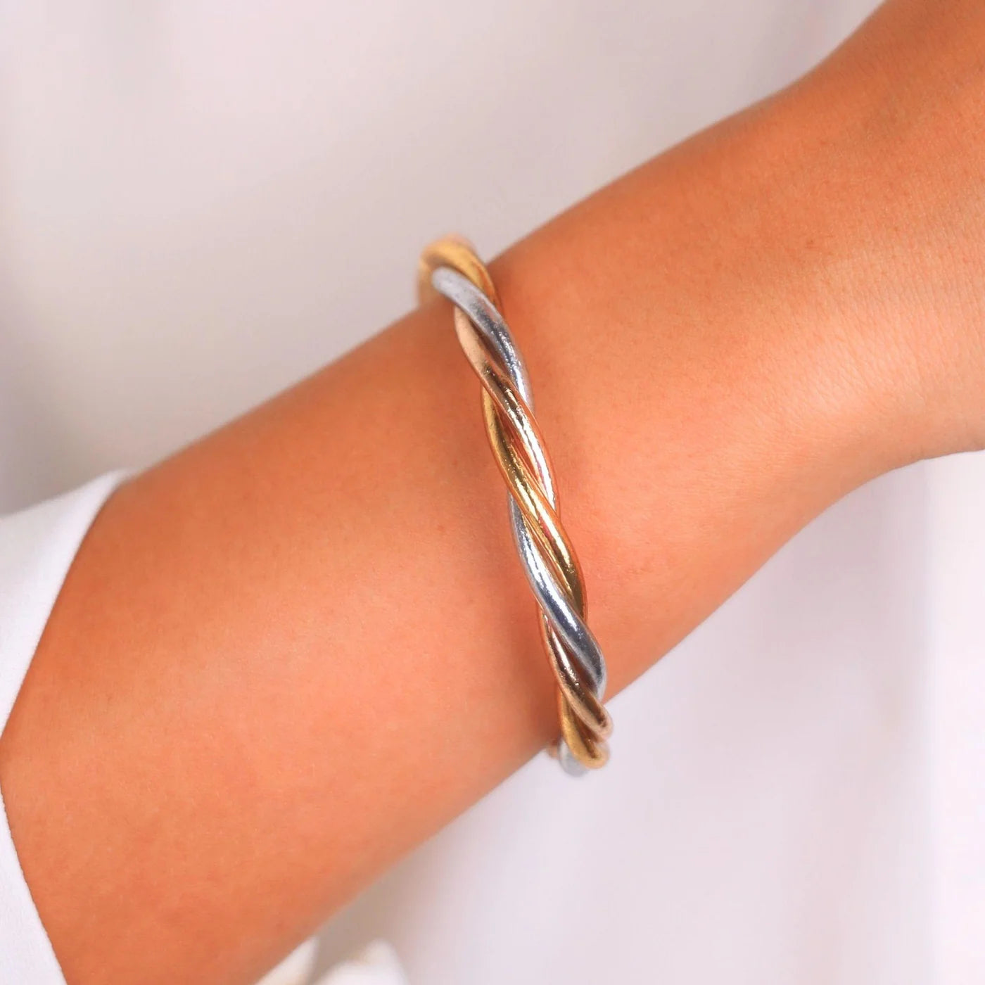 Trilogy All Weather Bangle with twisted gold, silver, and copper tones; available in small, medium, and large sizes.