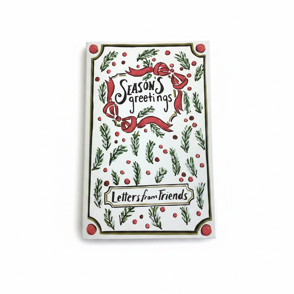 Multicolor canvas book storage boxes with holiday-themed print, red bows, pine sprigs, berries, and “Season’s greetings” and “Letters from Friends” text.