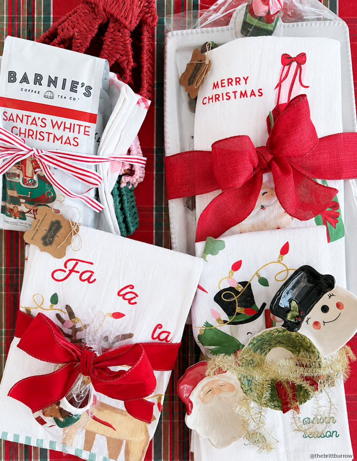 Three white Christmas-printed hand towels with festive holiday prints.