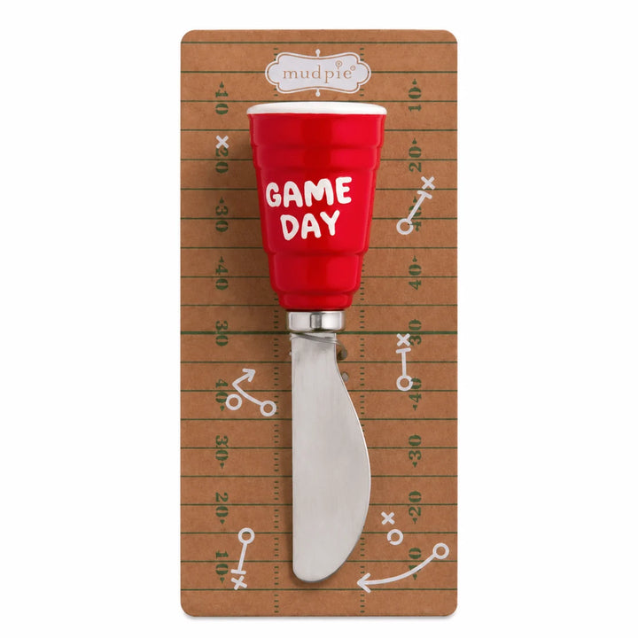 Cheese spreader with a red cup-shaped handle labeled “GAME DAY.” Available in 4 styles. Size options not specified.