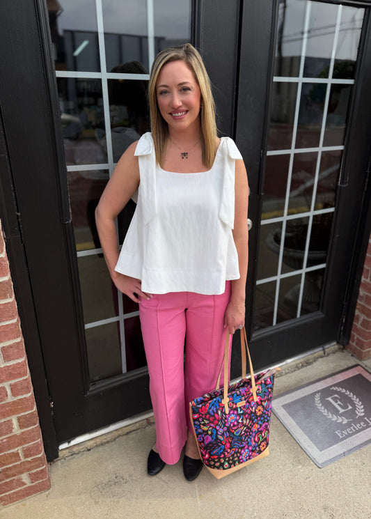 White scoop neck bow shoulder top; available in XS-XL.