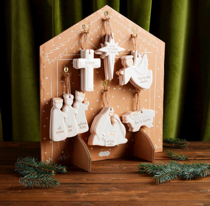 Seven white stoneware Nativity ornaments.