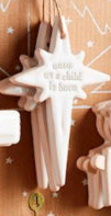 Star-shaped white stoneware Nativity ornaments engraved with “unto us a child is born.”.