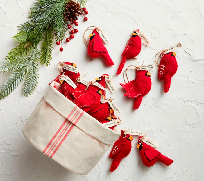 Red felt cardinal ornaments with small printed tags.
