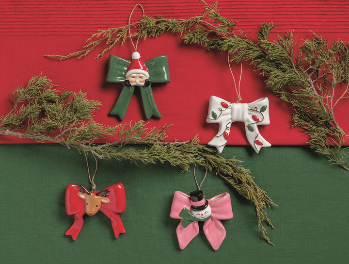 Hand-painted ceramic bow ornaments available in 4 styles: Santa, holly, reindeer, and snowman. Sizes available.