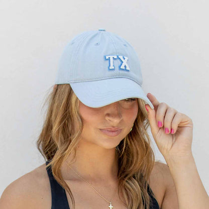 Texas Baseball Hat with light blue "TX" embroidery. Available in S, M, and L.