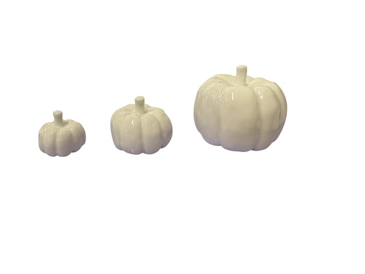 Set of three white porcelain pumpkins in small, medium, and large sizes.