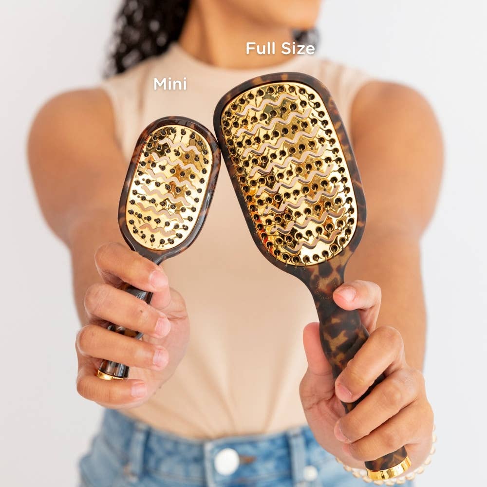 Mini Vented Brush | Tortoise shown in hand, highlighting its compact size. Available in mini size.
