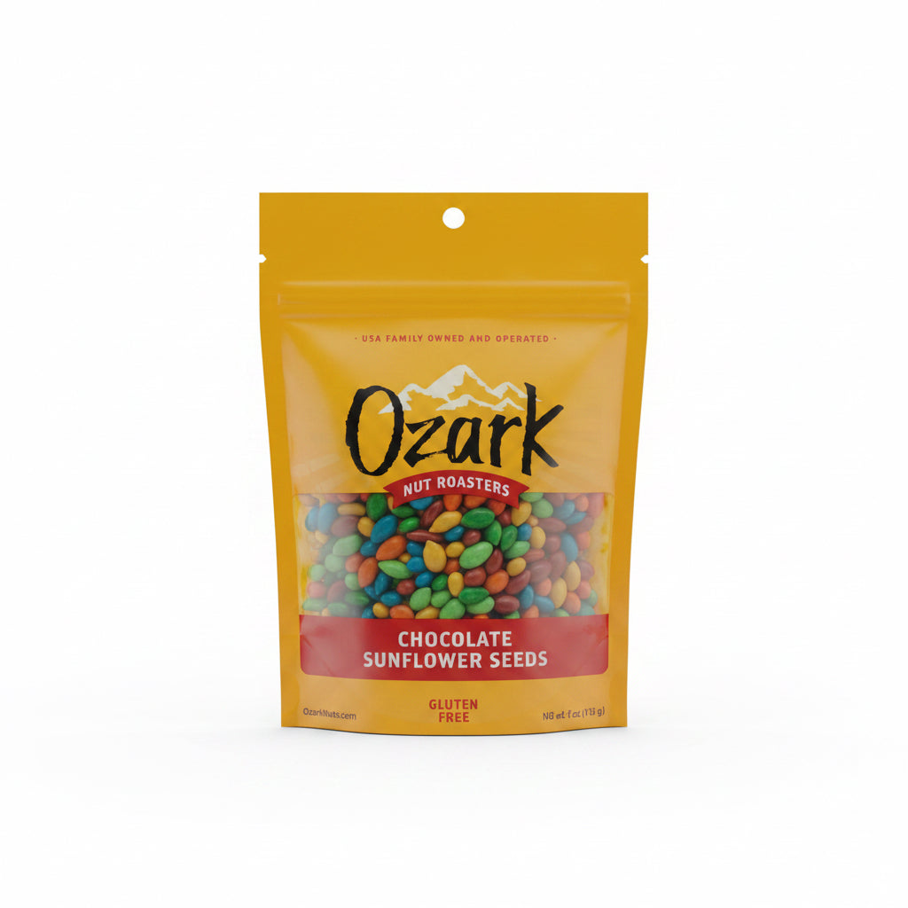Yellow resealable pouch of Chocolate Sunflower Seeds, candy-coated seeds visible through window, labeled gluten-free with mountain logo. Sizes available: 4oz, 8oz.