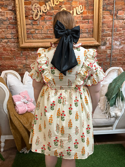 Butter Meadow Dress: cream floral ruffle dress with ruffled sleeves. Available in sizes XS–XL.