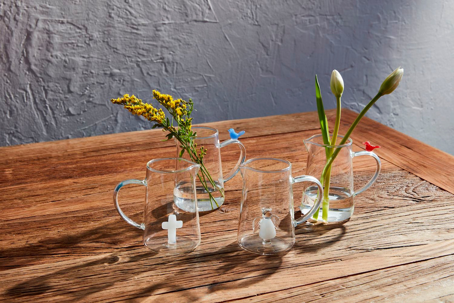 Clear glass mugs with small religious symbols, shown upright and inverted. Available in 250ml and 350ml sizes.